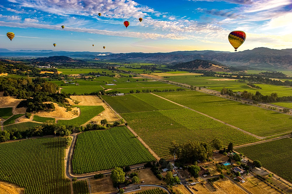Early morning start of a hot air balloon trip over Napa Valley CA vineyards