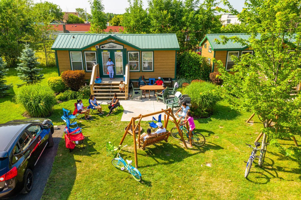 Family enjoys outside time at a KOA Deluxe Cabin