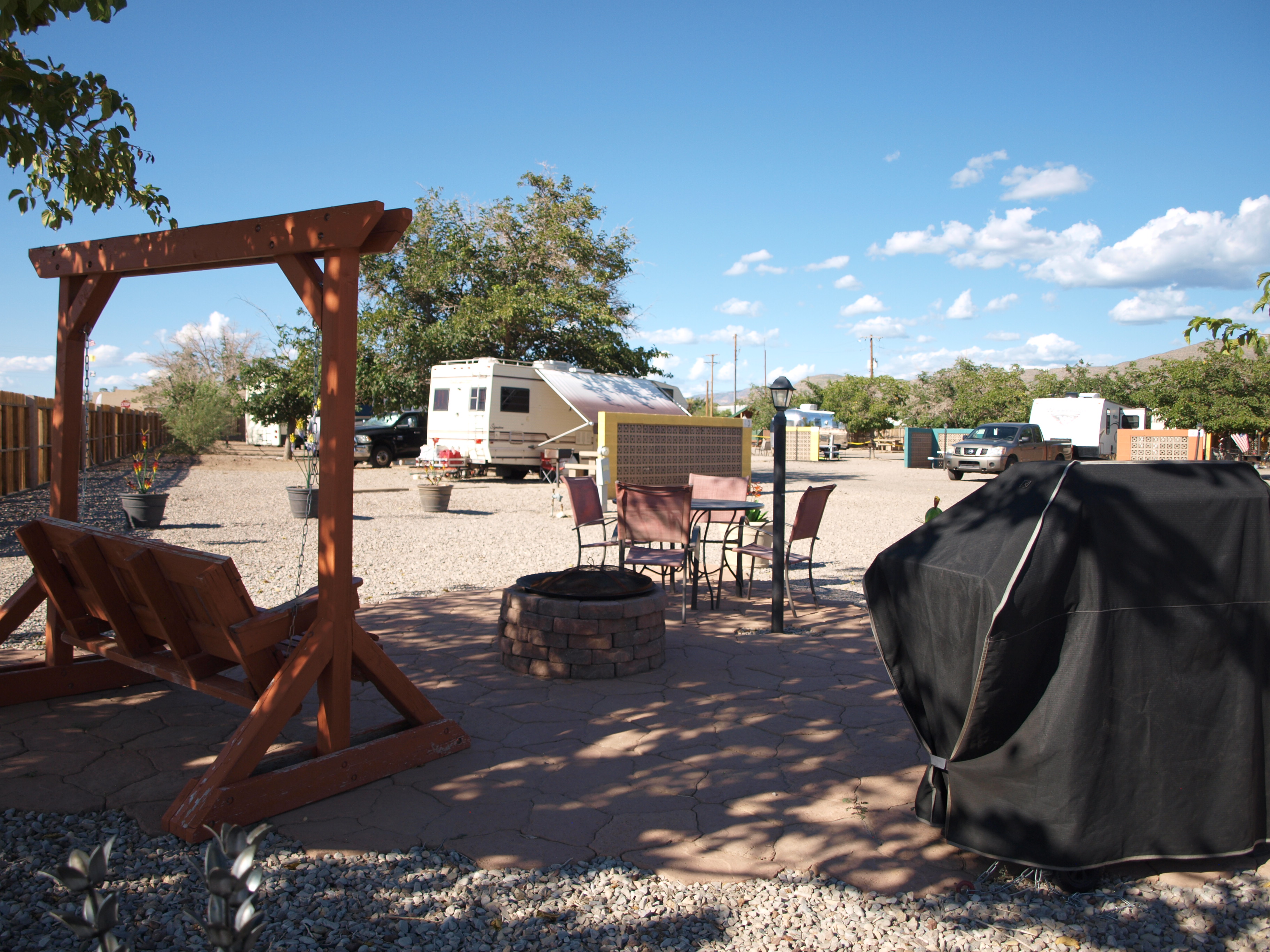 50/30amp back in, electric, water and sewer patio site.  Has gas BBQ grill and firepit.