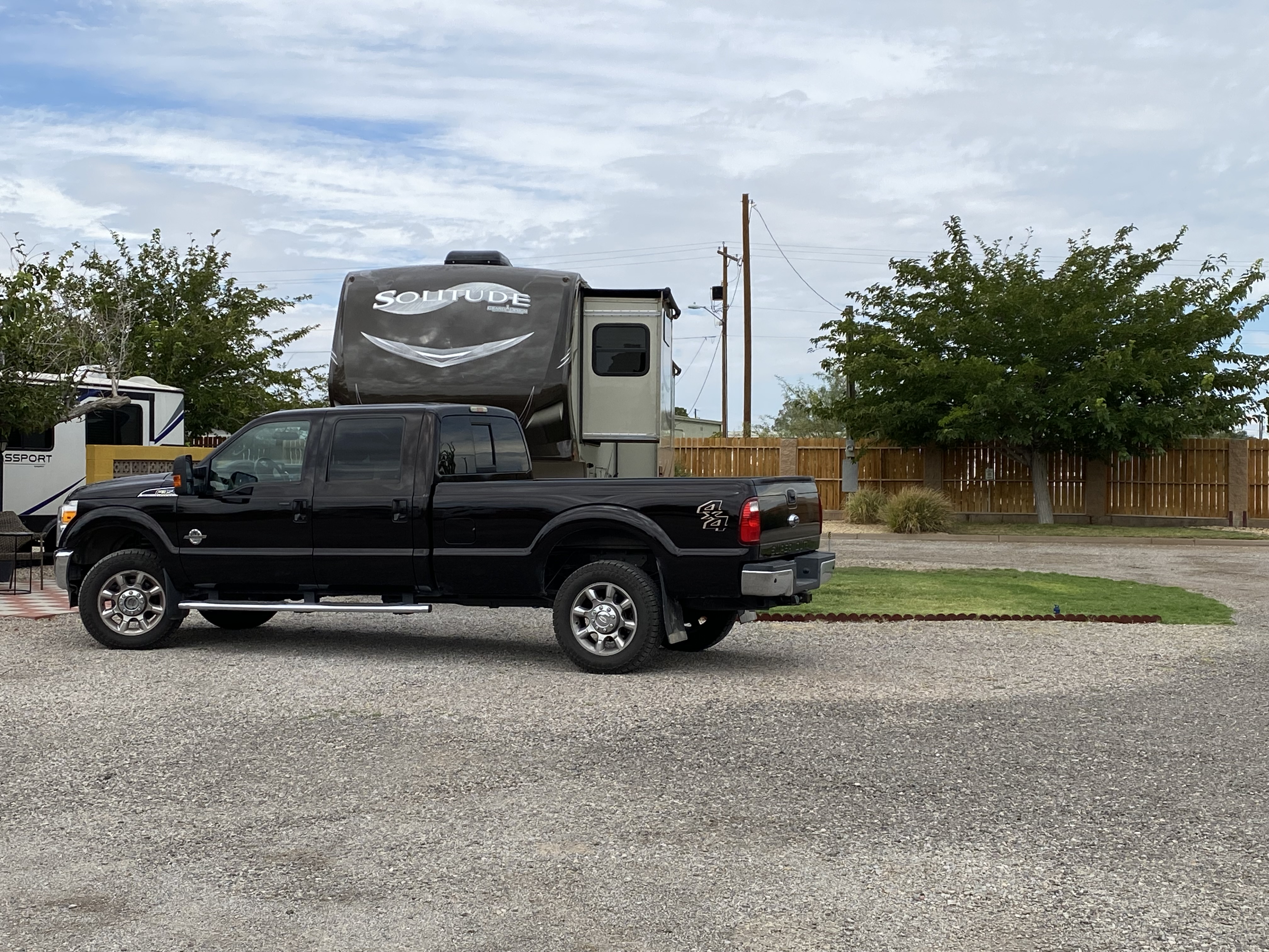 50/30amp back in patio site, water, sewer and cable tv.  Has gas BBQ grill and firepit.