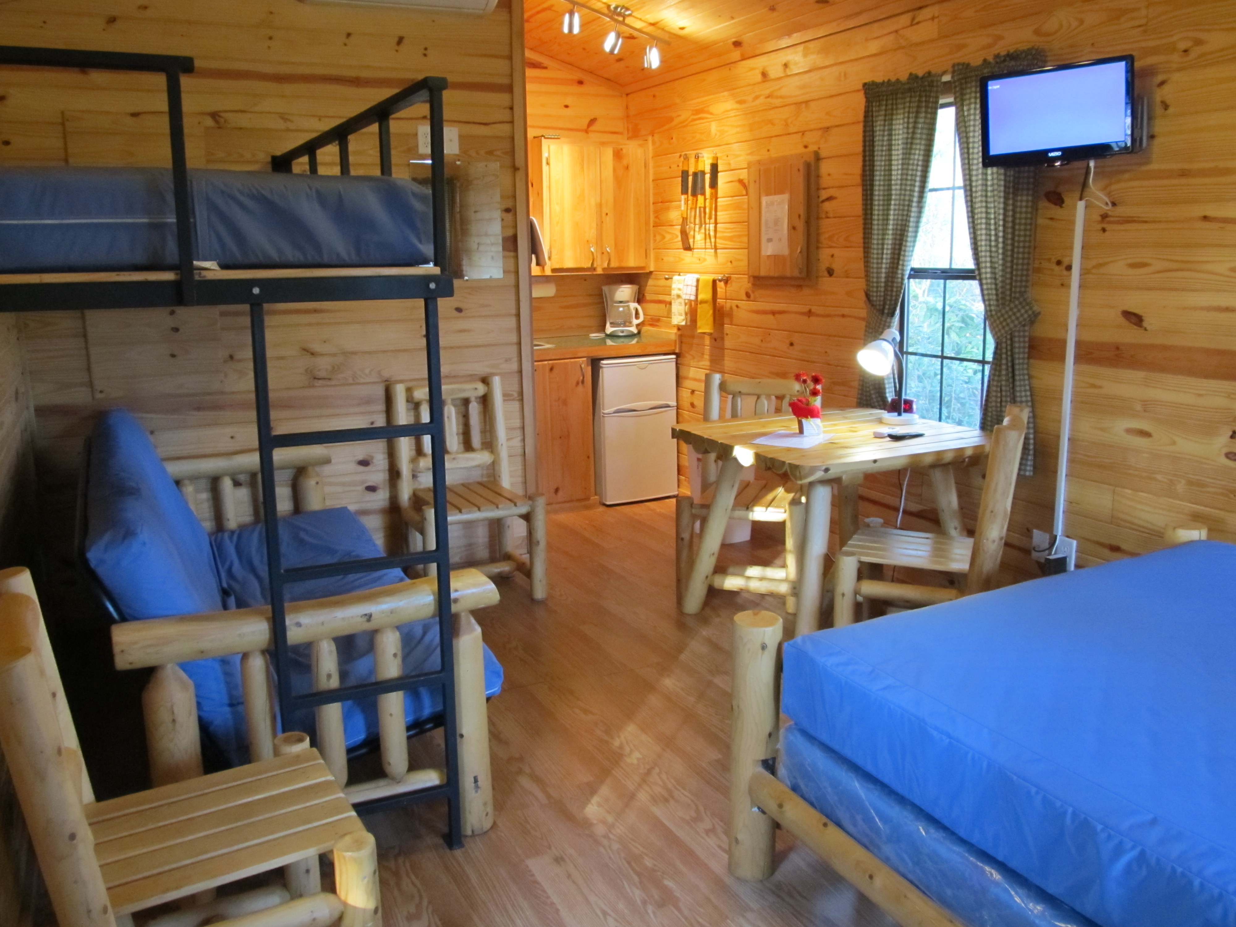 Deluxe Cabin-Park Model Interior with Cable TV, Kitchenette, Queen-size bed and Bunk Bed with Single on Top and Futon which opens to Full on Bottom (M01)
