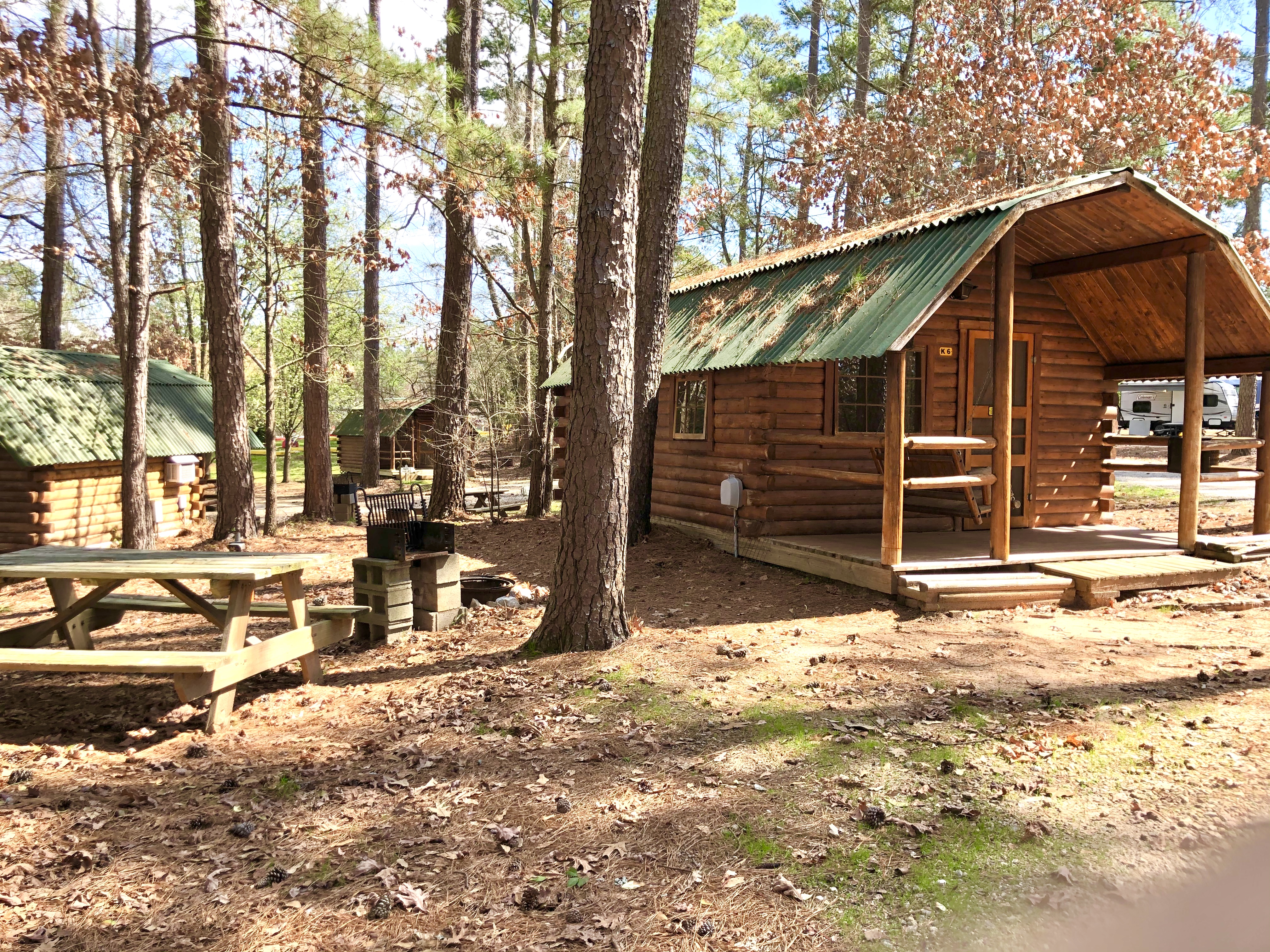 Two room camping cabin has a full size bed, mini-refrigerator, and a cable TV in front room and two sets of bunks and a cable TV in the back room. Bring the appropriate linens, etc.