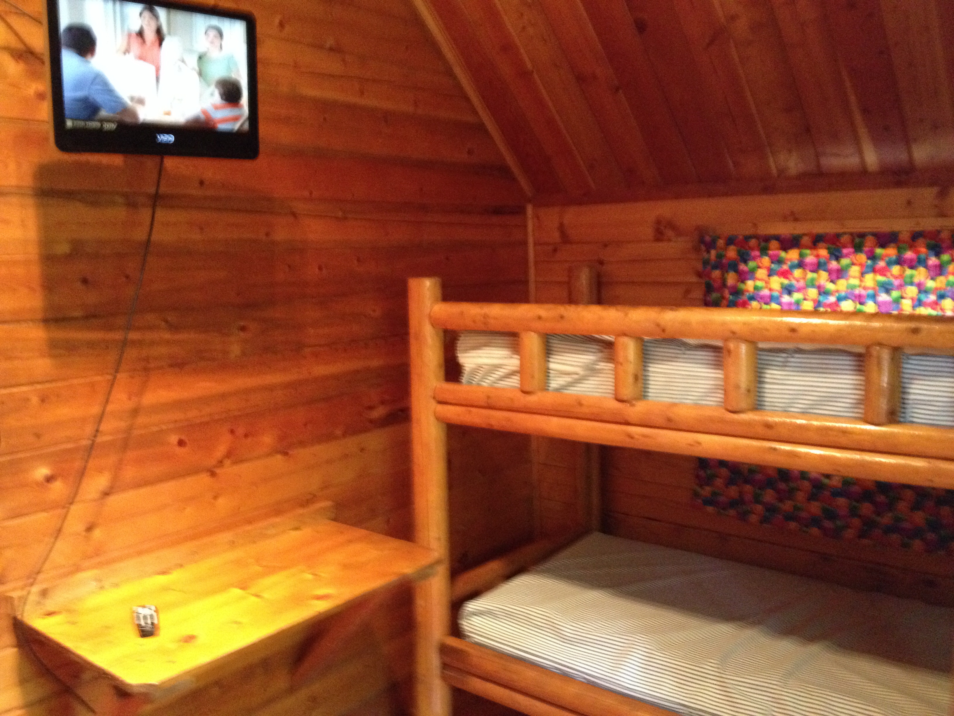 2-Room Camping Cabin Interior Back Room with Cable TV (K06) and two sets of bunks.