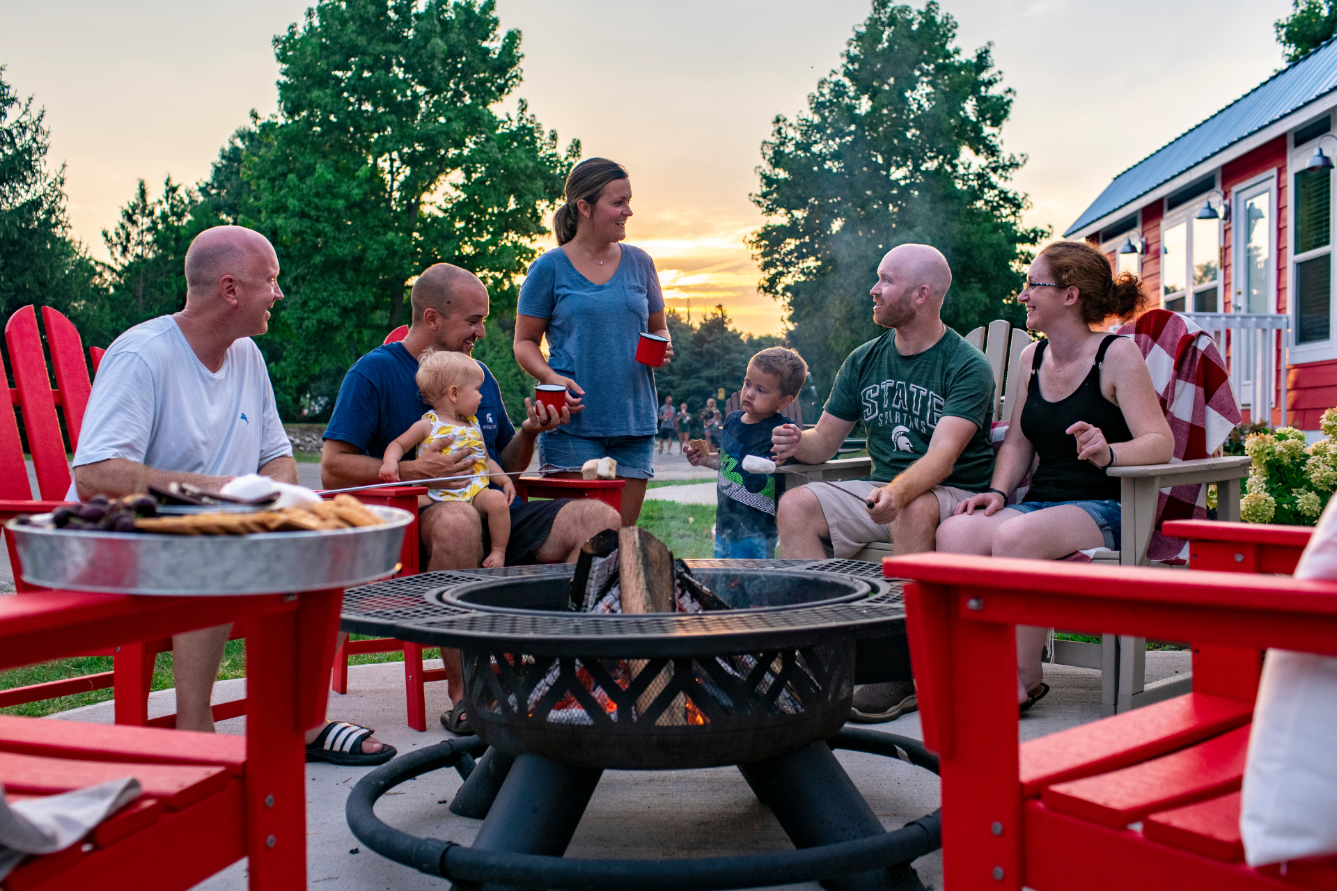 Family around Fire - Deluxe Cabin at Angola