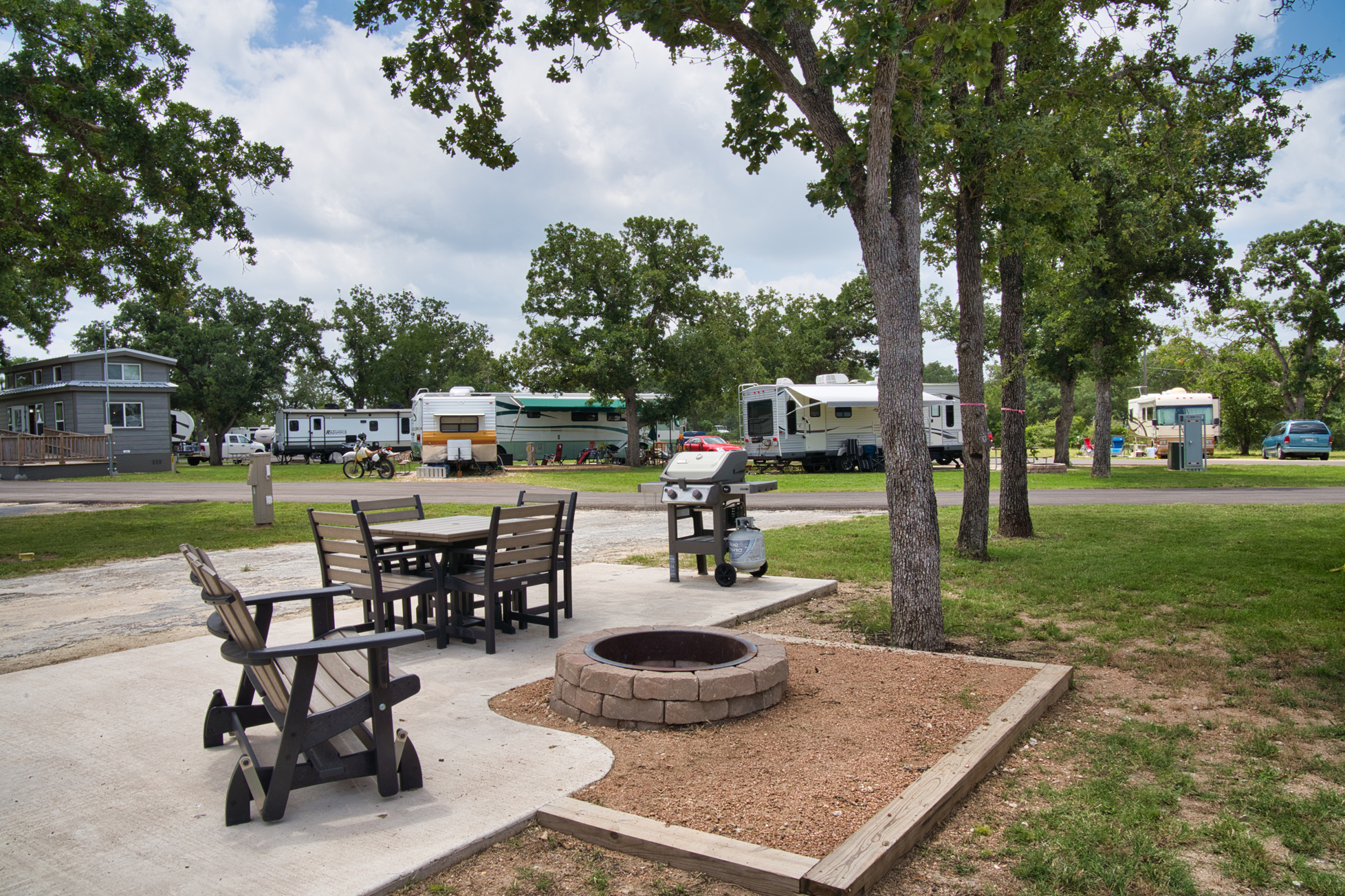 Deluxe Patio Site come with outdoor seating, fire pit, and gas grill.