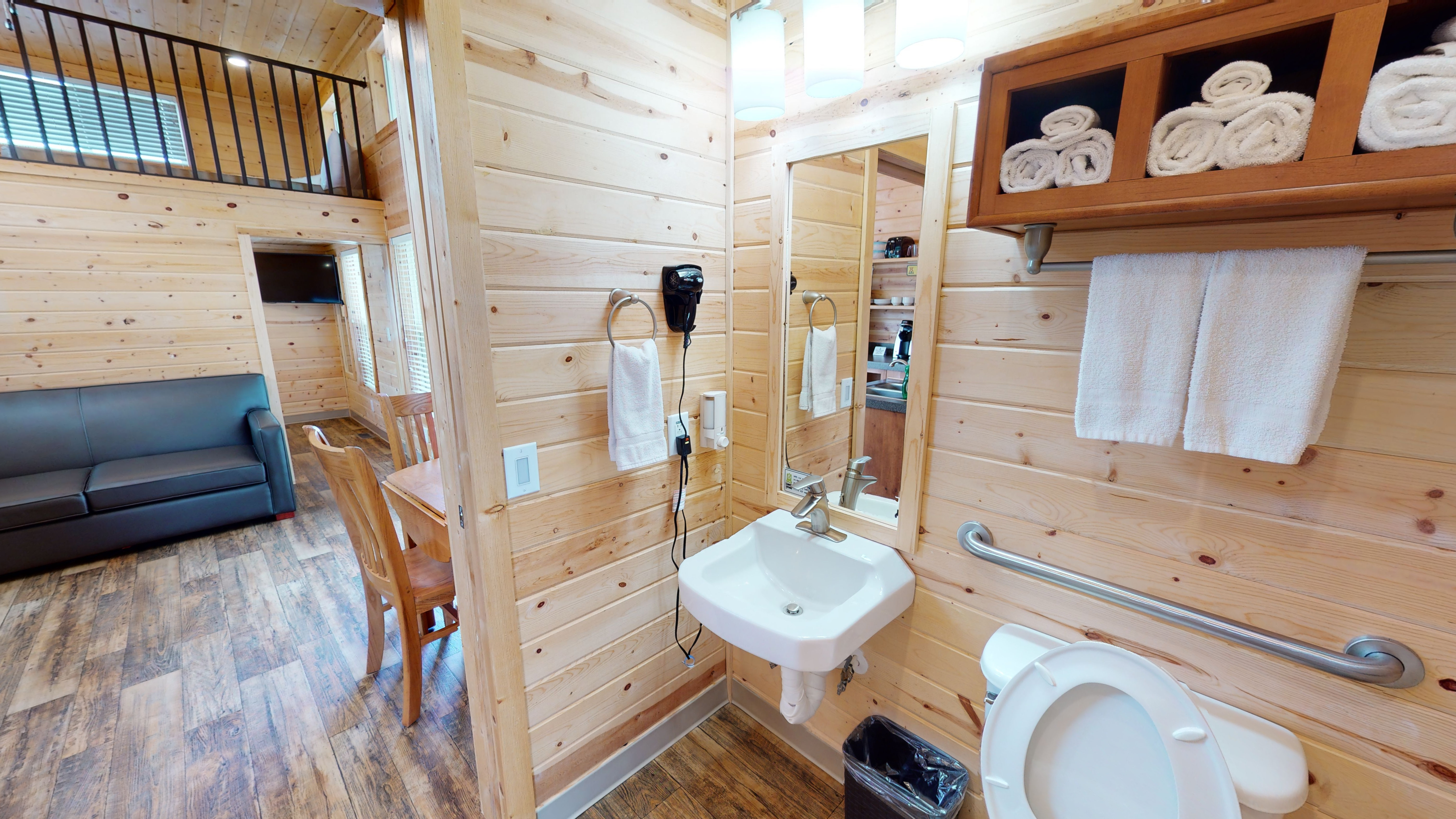ADA Deluxe Cabin Bathroom complete with towels and a hair dryer