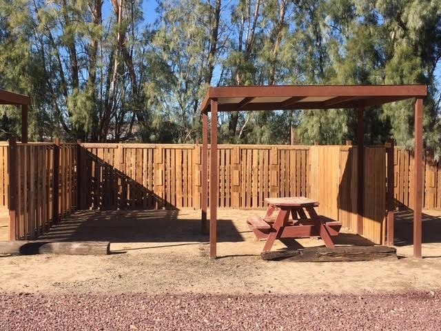 Privacy fence with shaded picnic table