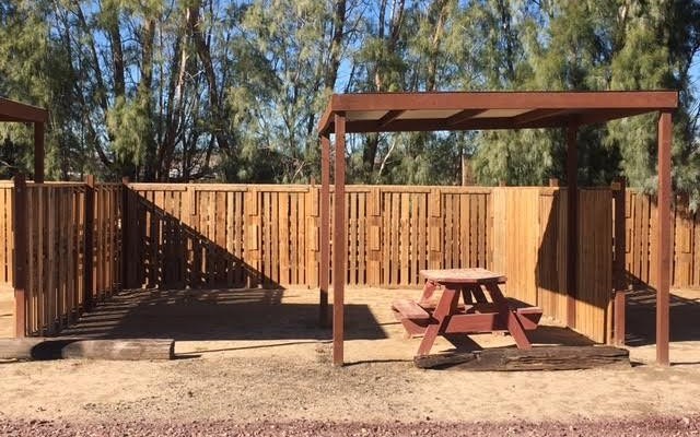Privacy fence with shaded picnic table