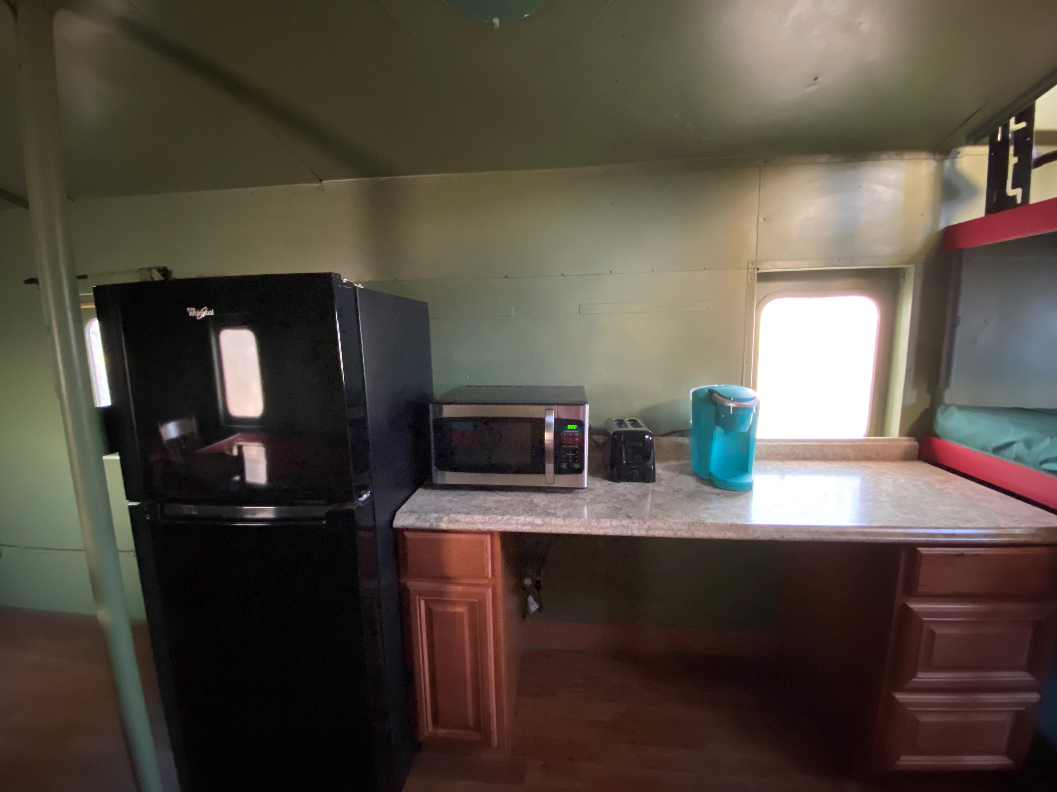 Partial Kitchen includes microwave, toaster, and Keurig coffee maker.