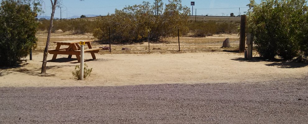 30' site with landscape on either side. Close to pool, playground & restrooms.