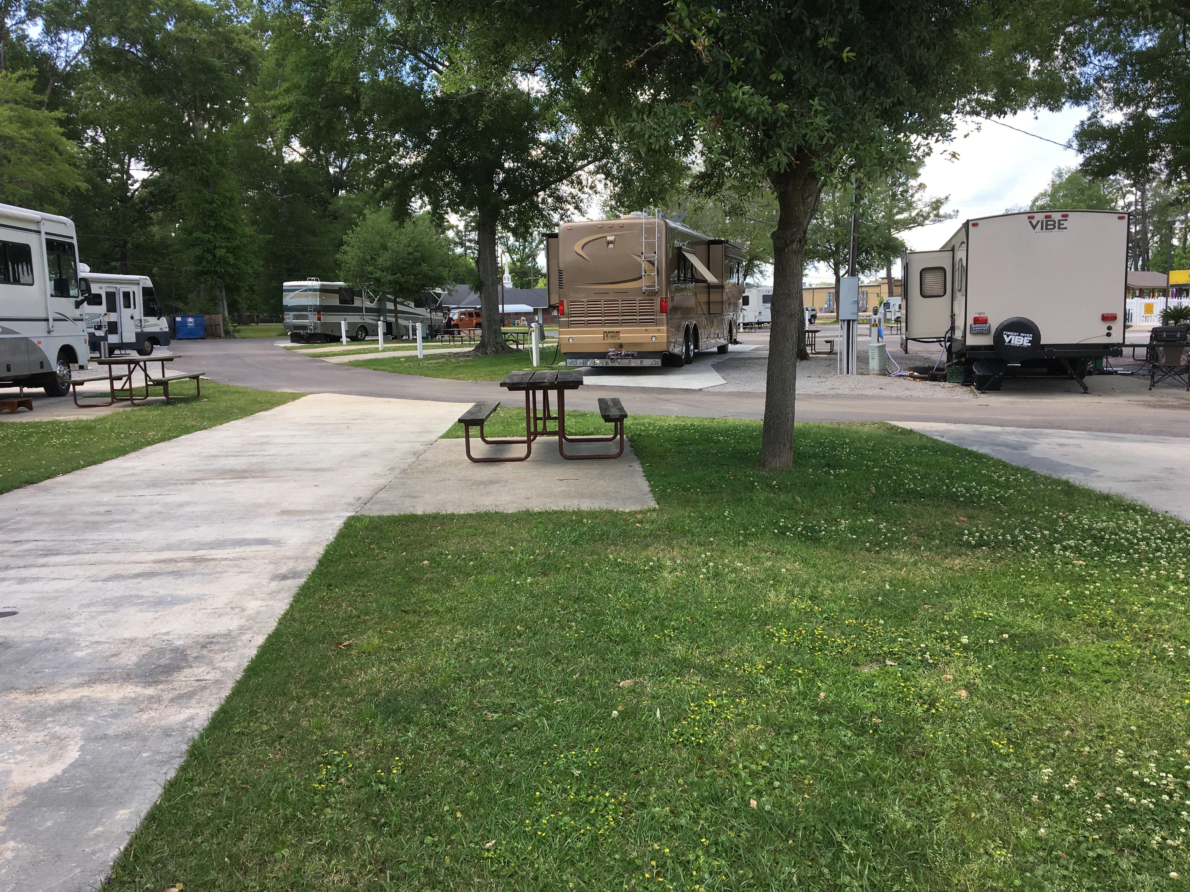 SITE 34 IS AN EXAMPLE OF ONE OF OUR FULL HOOKUP PULL-THRU SITES FEATURING A CONCRETE SLAB WITH PATIO WITH PICNIC TABLE, GRASS YARD, WATER, SEWER, 50/30/20 AMP ELECTRICITY, CABLE, AND WIRELESS INTERNET.