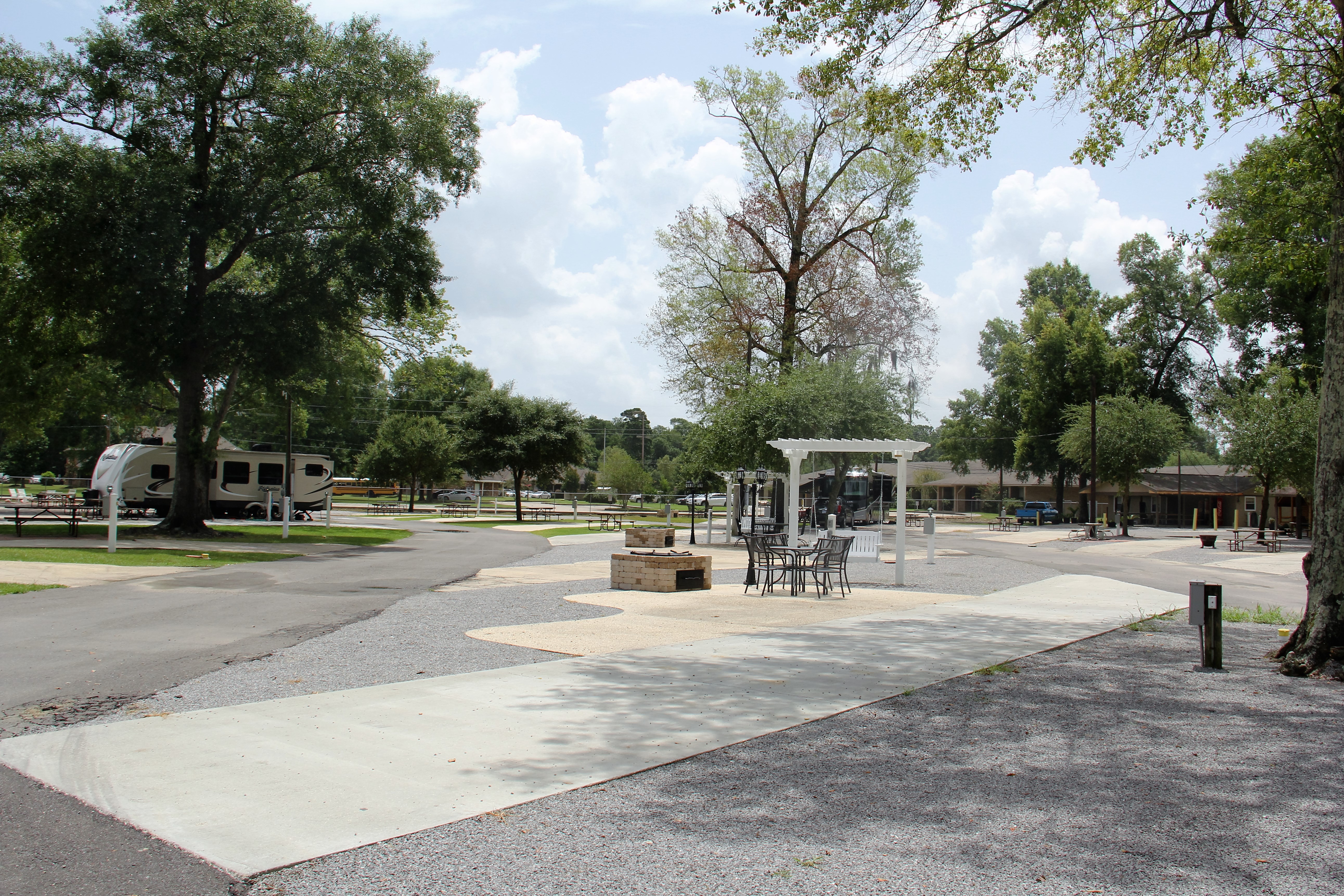 THIS IS AN EXAMPLE OF ONE OF OUR DELUXE PATIO SITES. THESE SITES ARE FEATURING A LONG PULL-THRU CONCRETE SLAB AND CONCRETE PATIO WITH PATIO FURNITURE TO SIT AND ENJOY THE BRICK FIRE PIT/BBQ PIT. WATER, SEWER, 50/30/20 AMP ELECTRIC, CABLE, WIRELESS INTERNET INCLUDED WITH ALL OUR DELUXE SITES.