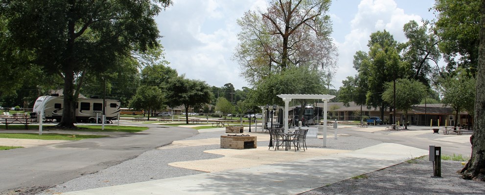 THIS IS AN EXAMPLE OF ONE OF OUR DELUXE PATIO SITES. THESE SITES ARE FEATURING A LONG PULL-THRU CONCRETE SLAB AND CONCRETE PATIO WITH PATIO FURNITURE TO SIT AND ENJOY THE BRICK FIRE PIT/BBQ PIT. WATER, SEWER, 50/30/20 AMP ELECTRIC, CABLE, WIRELESS INTERNET INCLUDED WITH ALL OUR DELUXE SITES.