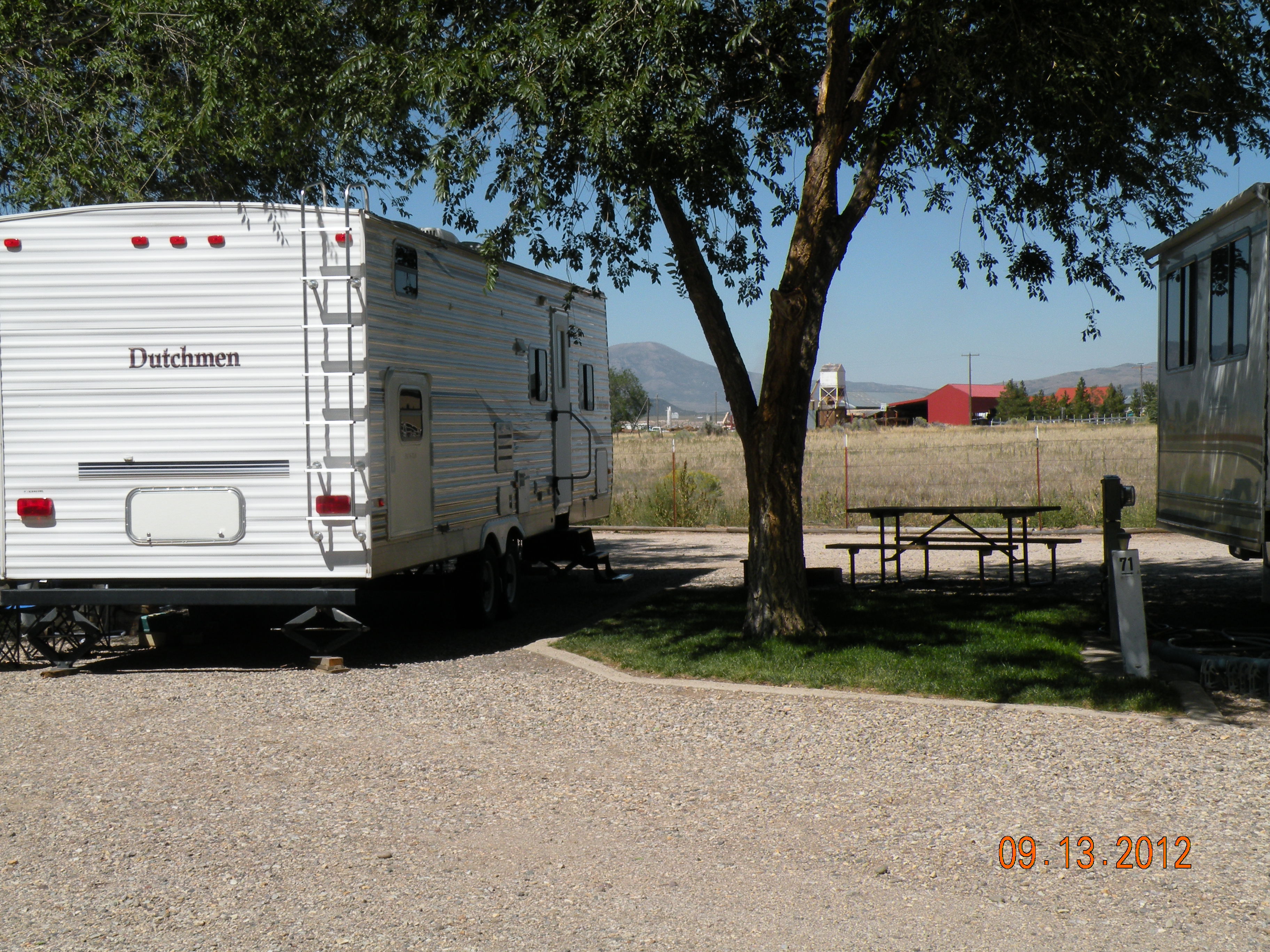 45 Feet long. Full  hookups. 30 amps. View of field, nice shade and grass