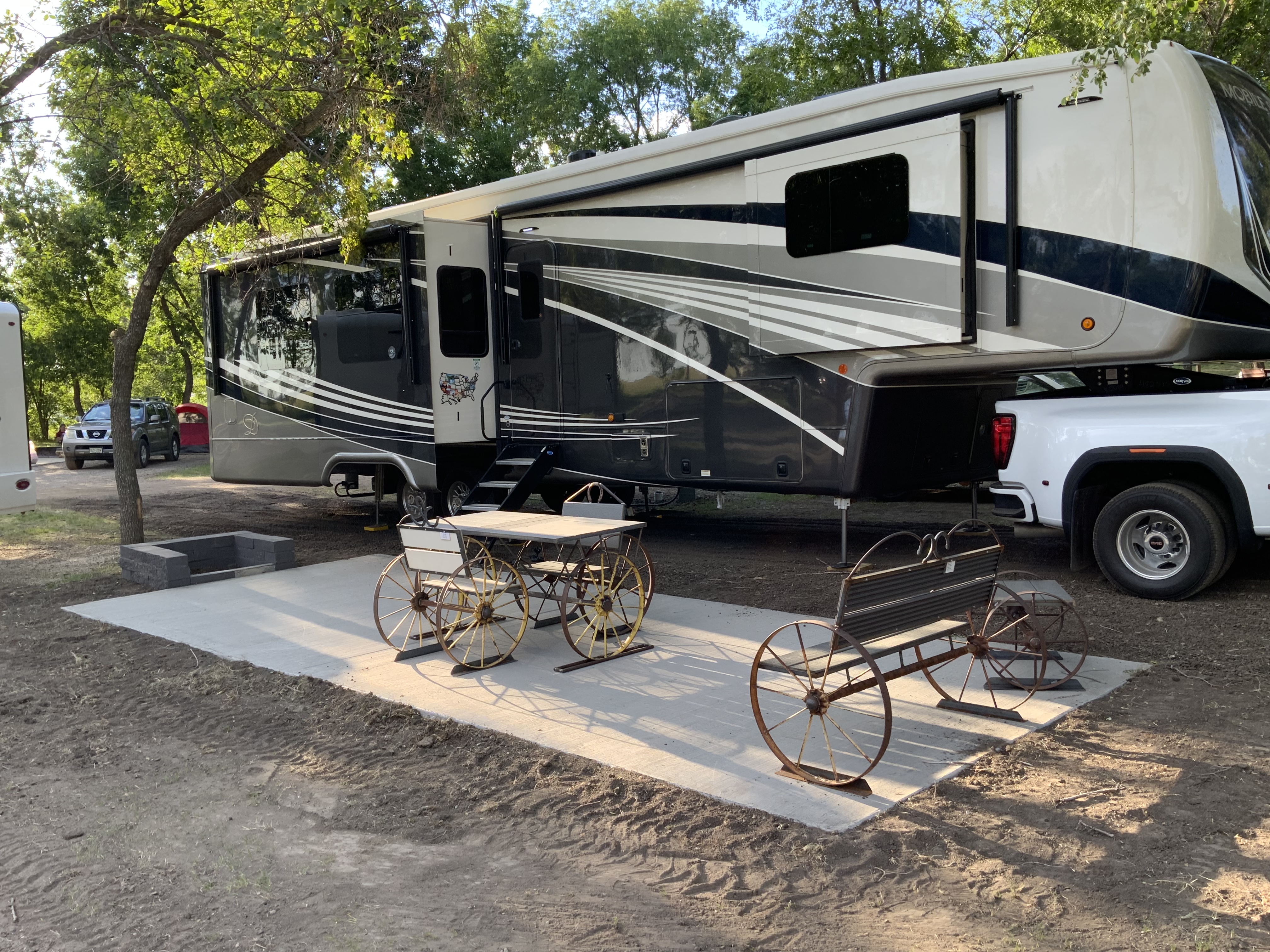 Our new patio sites with built in stone fire pit. With these beautiful wagon wheel tables and bench’s