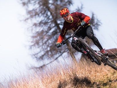 Mountain Biker doing a bike trick while going down the Cowles Mountain trail. 