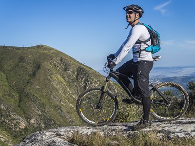 Man overlooks Noble Canyon while sitting on his bike.