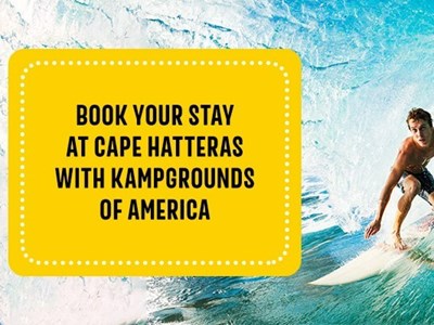 Man surfing in the water on the Cape Hatteras/Outer Banks KOA shore