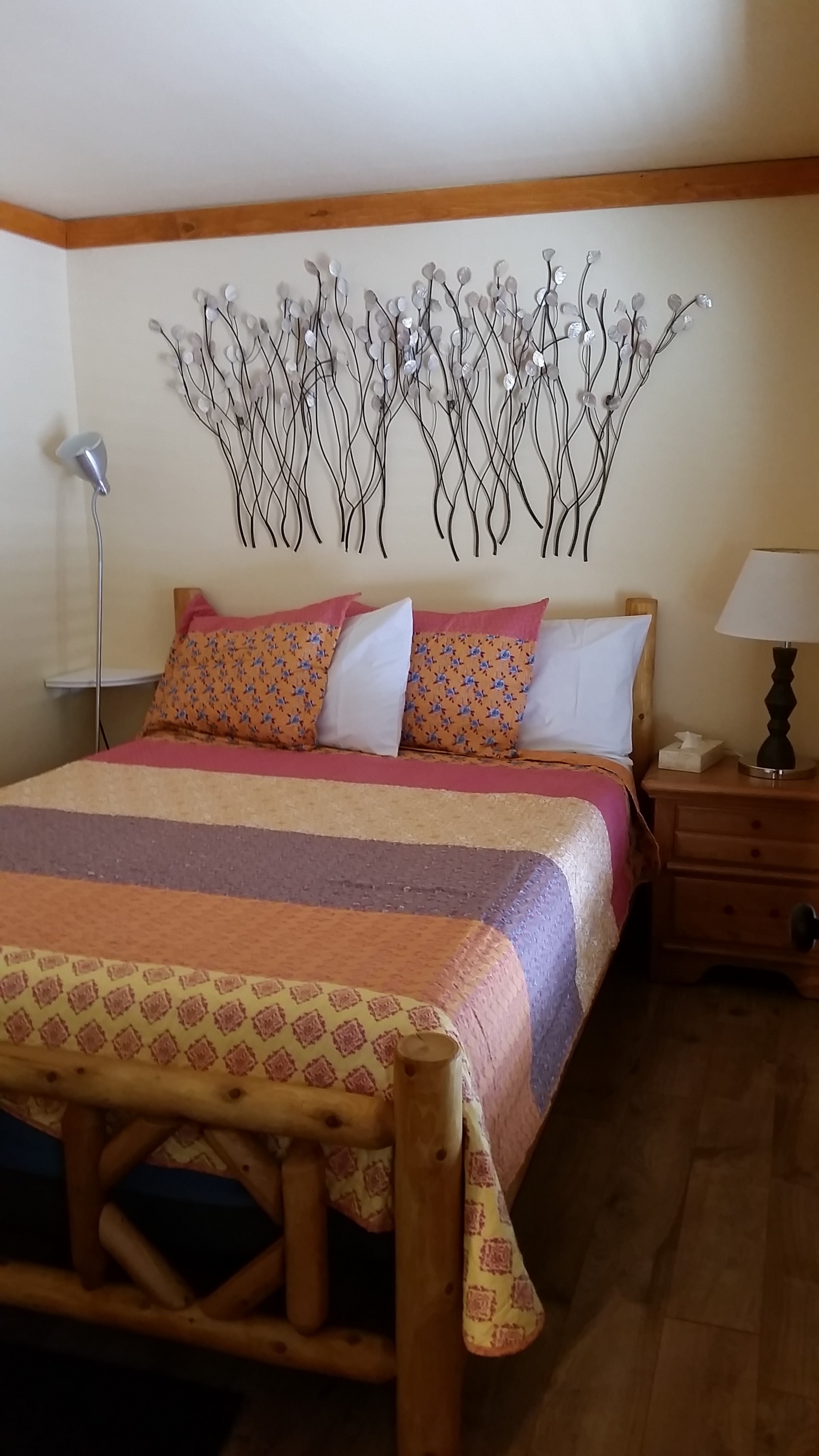 Front bedroom offers a comfy new log queen bed.