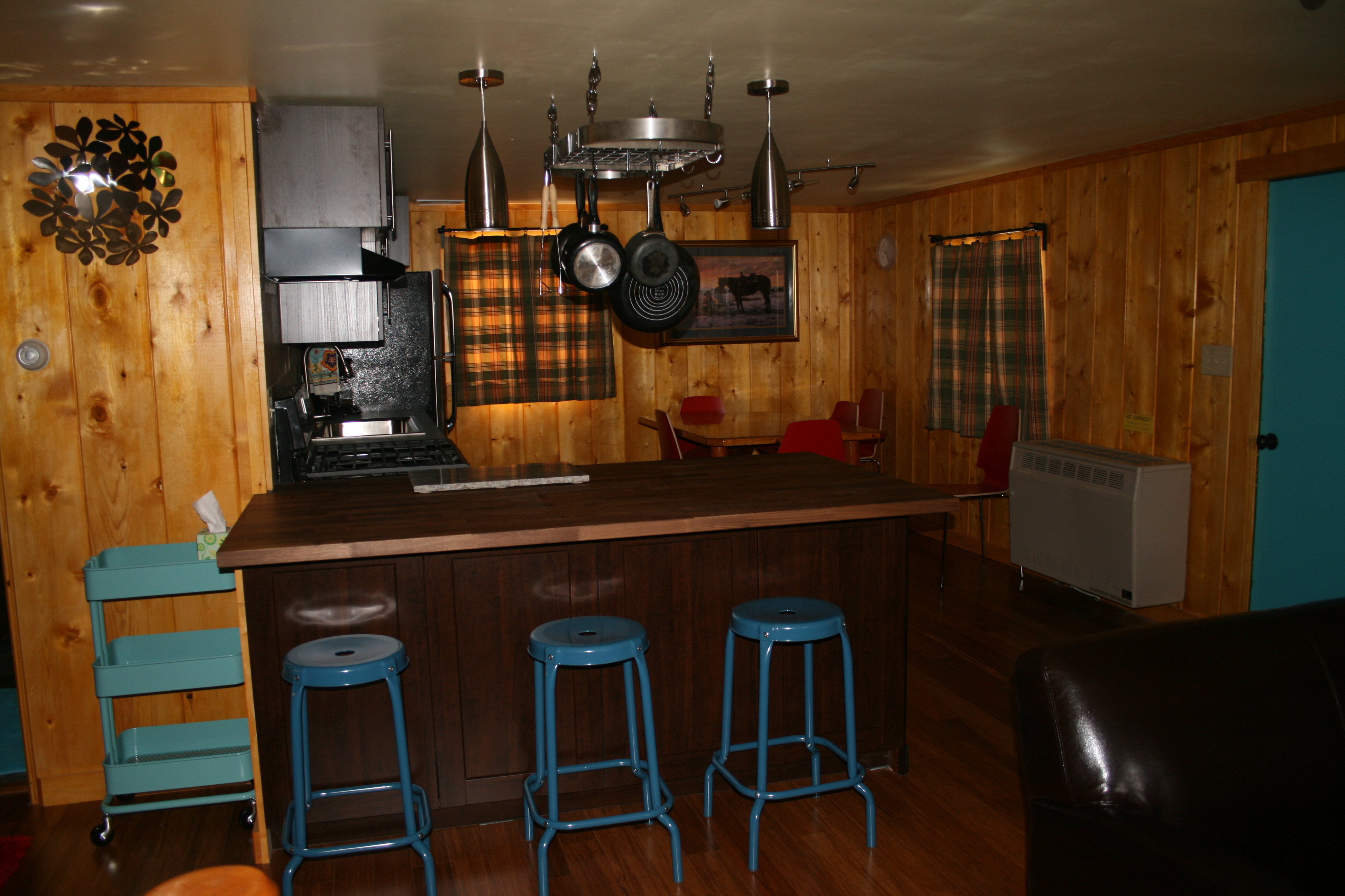 Large eating bar joins living with kitchen