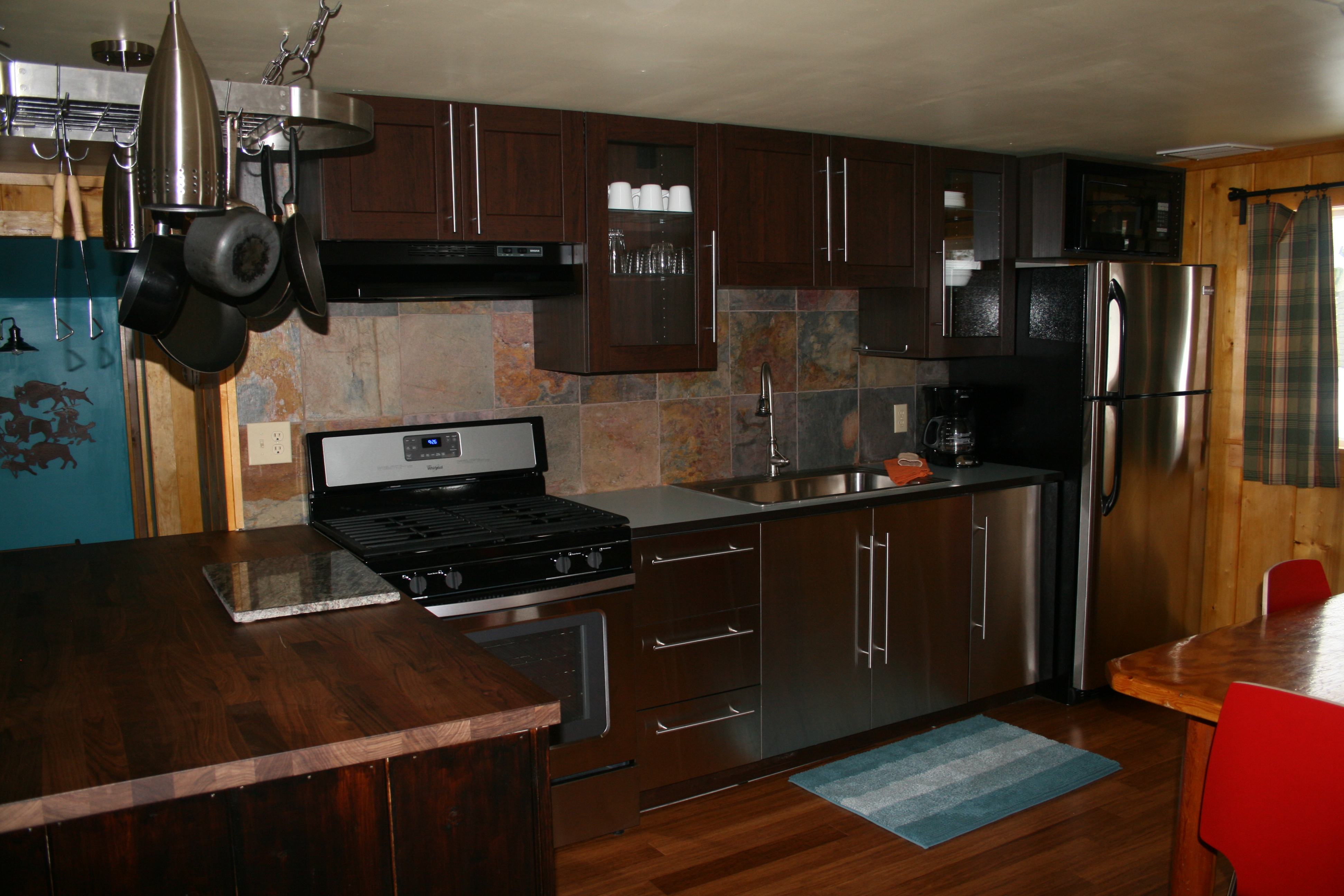 Fully equipped and modern kitchen contrast with the rustic log cabin