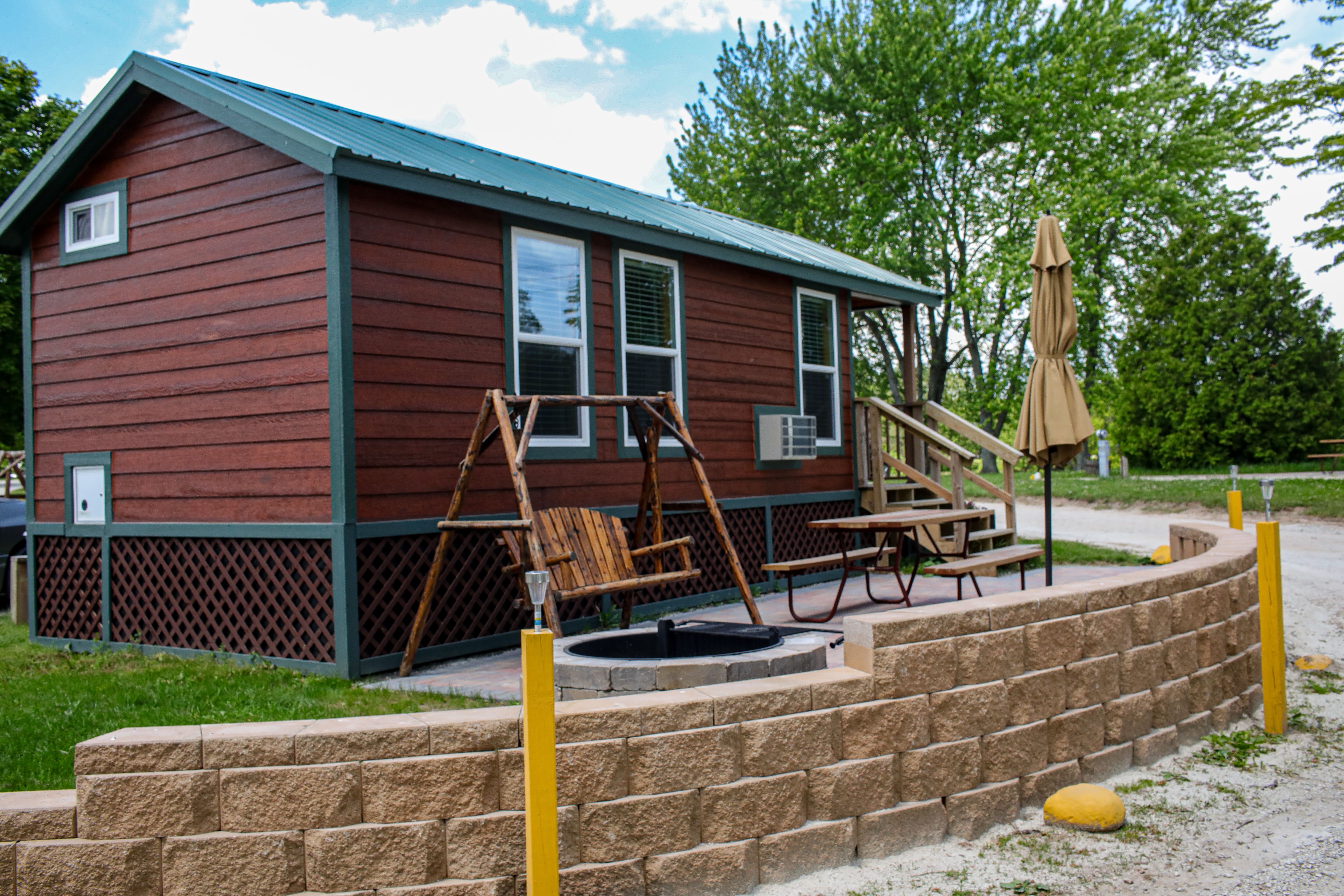 Studio lodge with large brick patio. Enjoy your campfire and watch your barbecue  sizzle from the comfort of a patio swing!