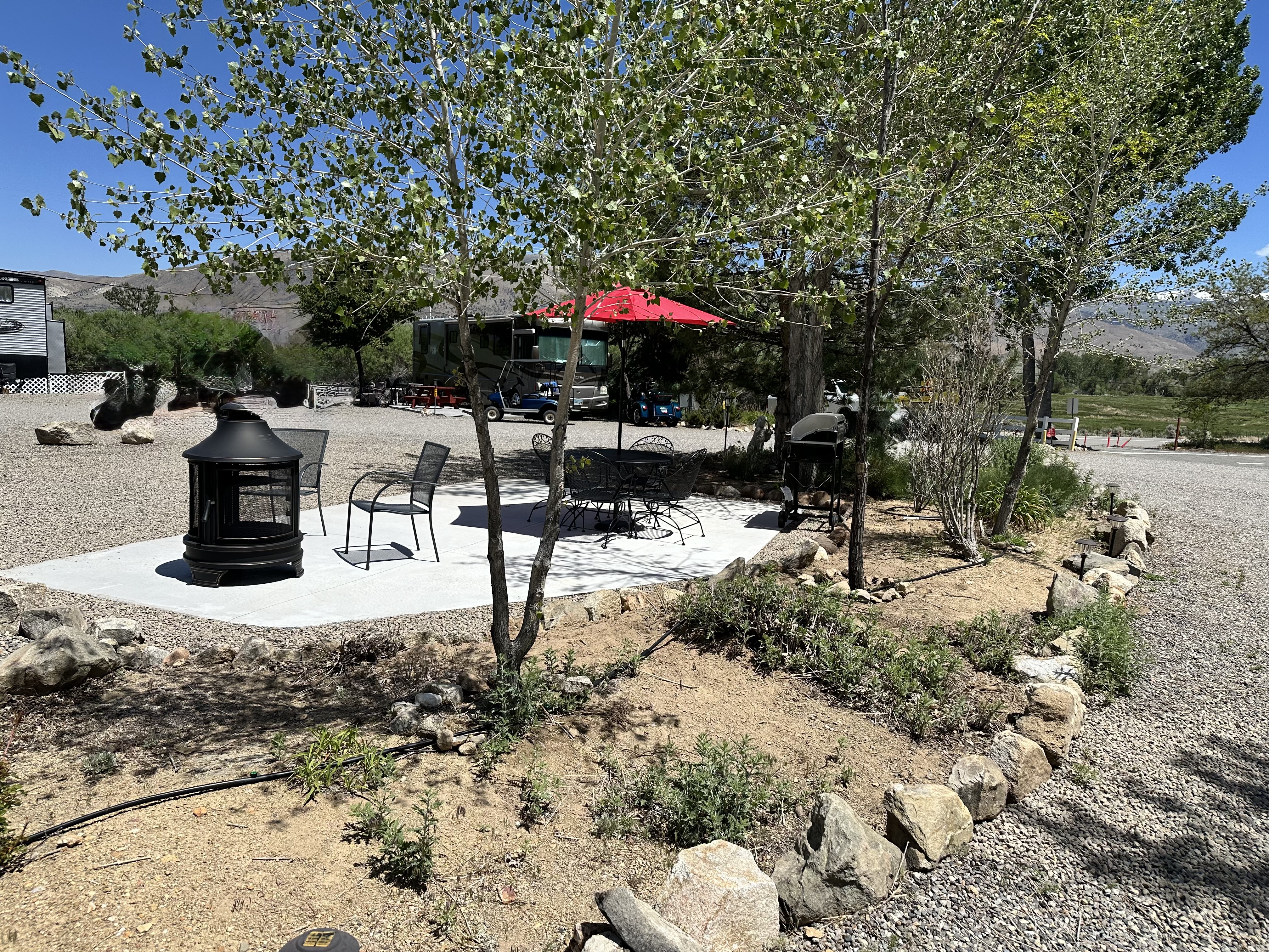 Rv pull thru patio bushes trees