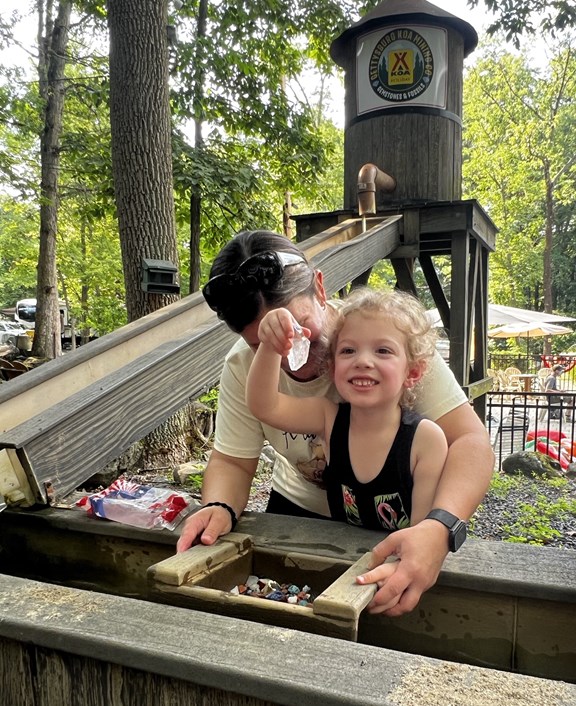 Smiling girl showing off her gemstone find at Gettysburg KOA