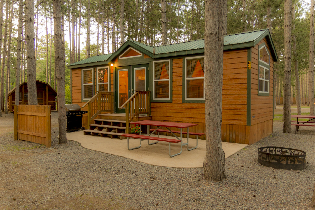Luxury in the pines.  These deluxe cabins are family ready with kitchenettes, baths, patios, grills, fire rings and more.  They sleep 6 in a variety of floor-plans.  Your's awaits!