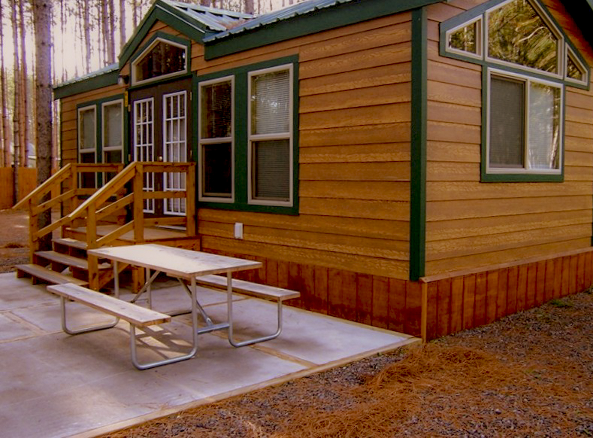 Luxury in the pines.  These deluxe cabins are family ready with kitchenettes, baths, patios, grills, fire rings and more.  They sleep 6 in a variety of floor-plans.  Your's awaits!