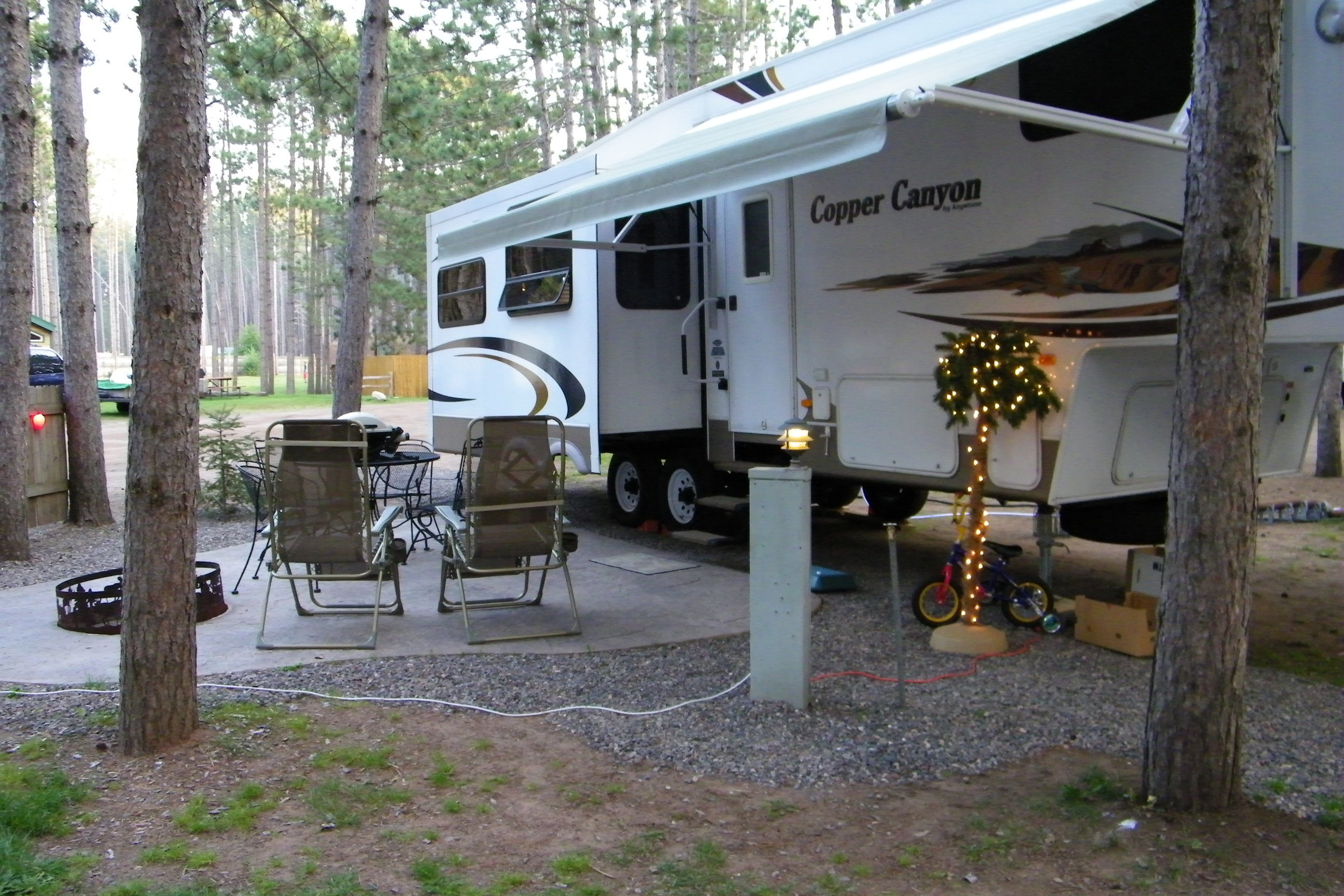Patios, fire rings, seating and tables - our deluxe RV sites are the place to sit back and relax under the tall pines.  Back-ins or pull-throughs, your favorite space awaits!