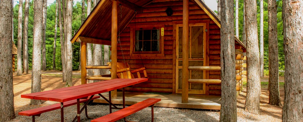 Enjoy our beautiful rustic cabins nestled in the pines.  They are either one bedroom sleeping 4 or two bedrooms sleeping 6.  All have porches, fire rings and picnic table.  Why stay in a motel?