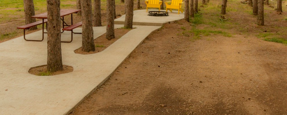 Patios, fire rings, seating and tables - our deluxe RV sites are the place to sit back and relax under the tall pines.  Back-ins or pull-throughs, your favorite space awaits!