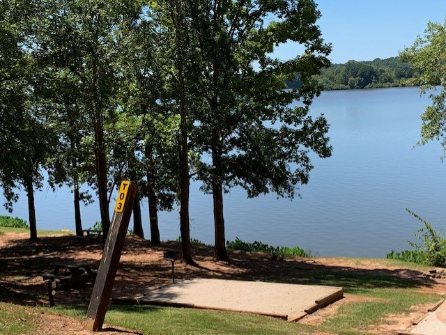 Lake side tent site equipped with a 12x12 sand pad for your tent.