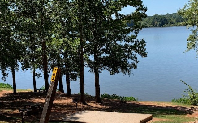 Lake side tent site equipped with a 12x12 sand pad for your tent.