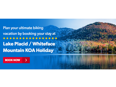 Wide view of the hilly landscape over Lake Placid with the leaves changing color