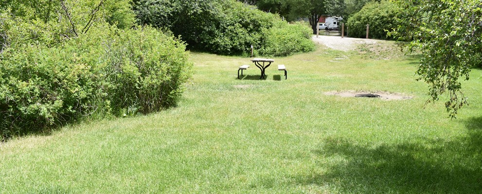 Multiple tent site. 3 tents, 6 people, 2 cars. Site has fire pit, charcoal grill, picnic table, and a power.