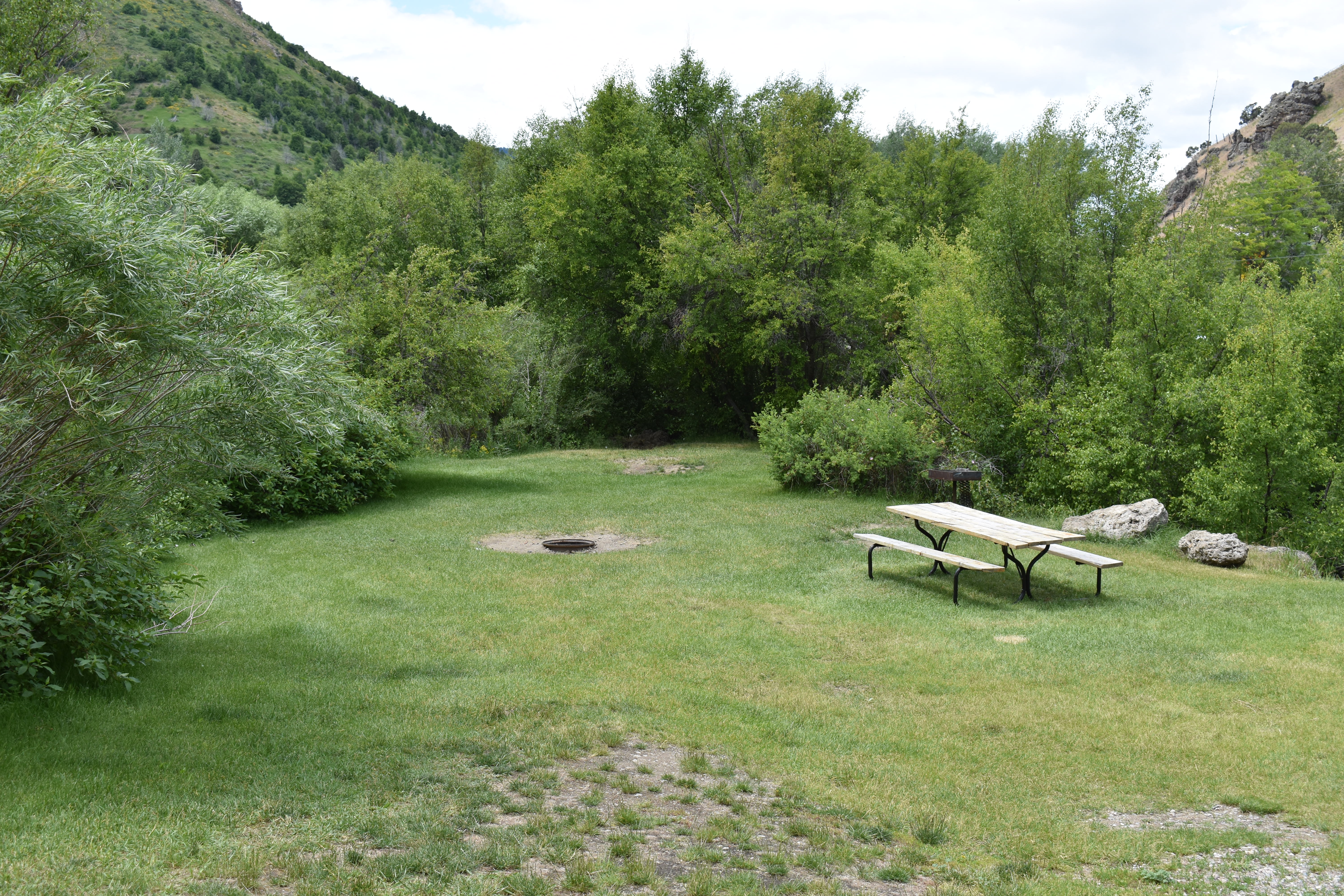 Tent Site #TS1 Multiple tent site. 3 tents, 6 people, 2 cars. Site has fire pit, charcoal grill, picnic table, and a power.