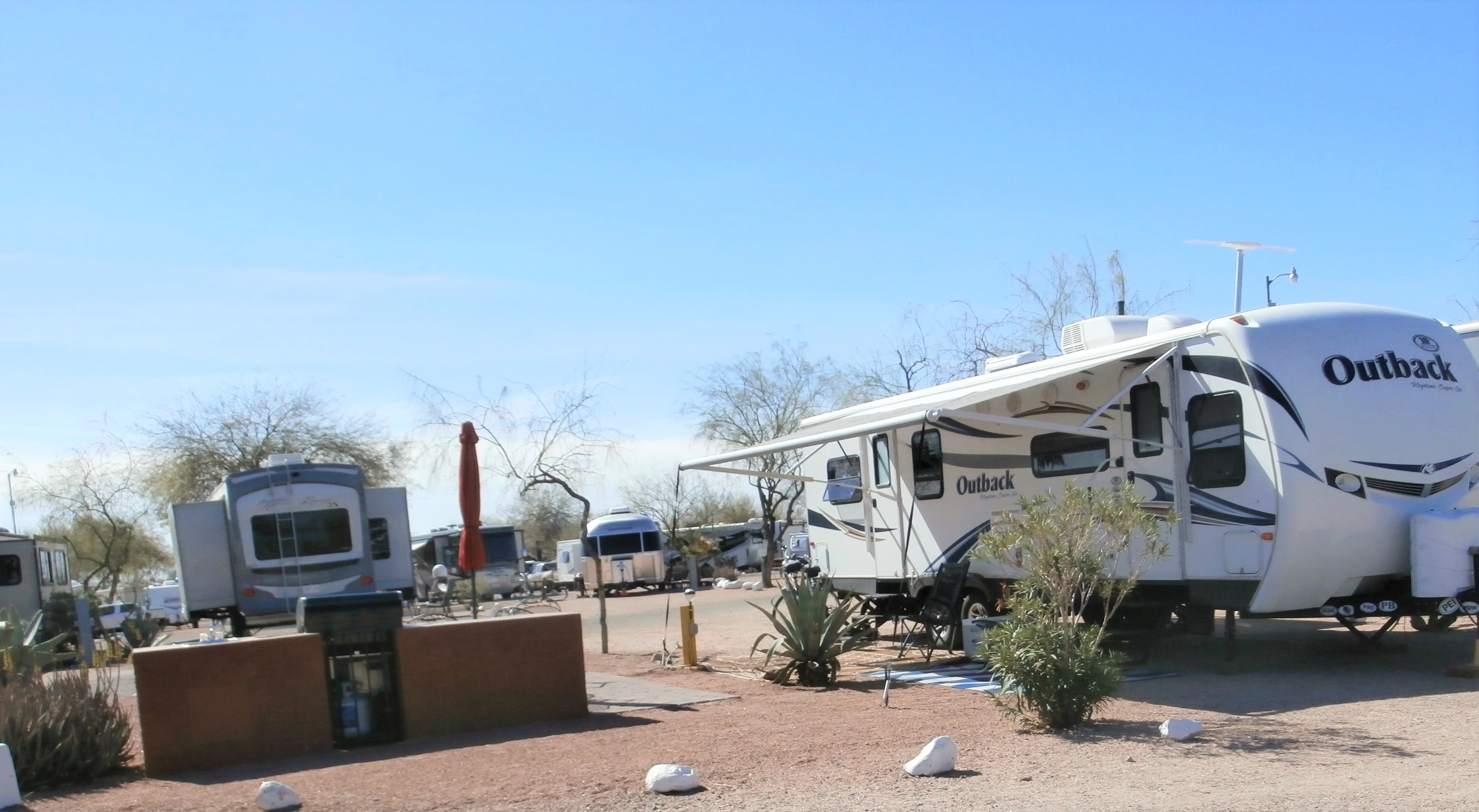 Pull Thru, 50/30 Amps, Full Hookups, Deluxe Patio Site Deluxe patio beautifully landscaped, specialty patio furniture, gas barbecue and sink. Best view of the Superstitions. Limited number available.