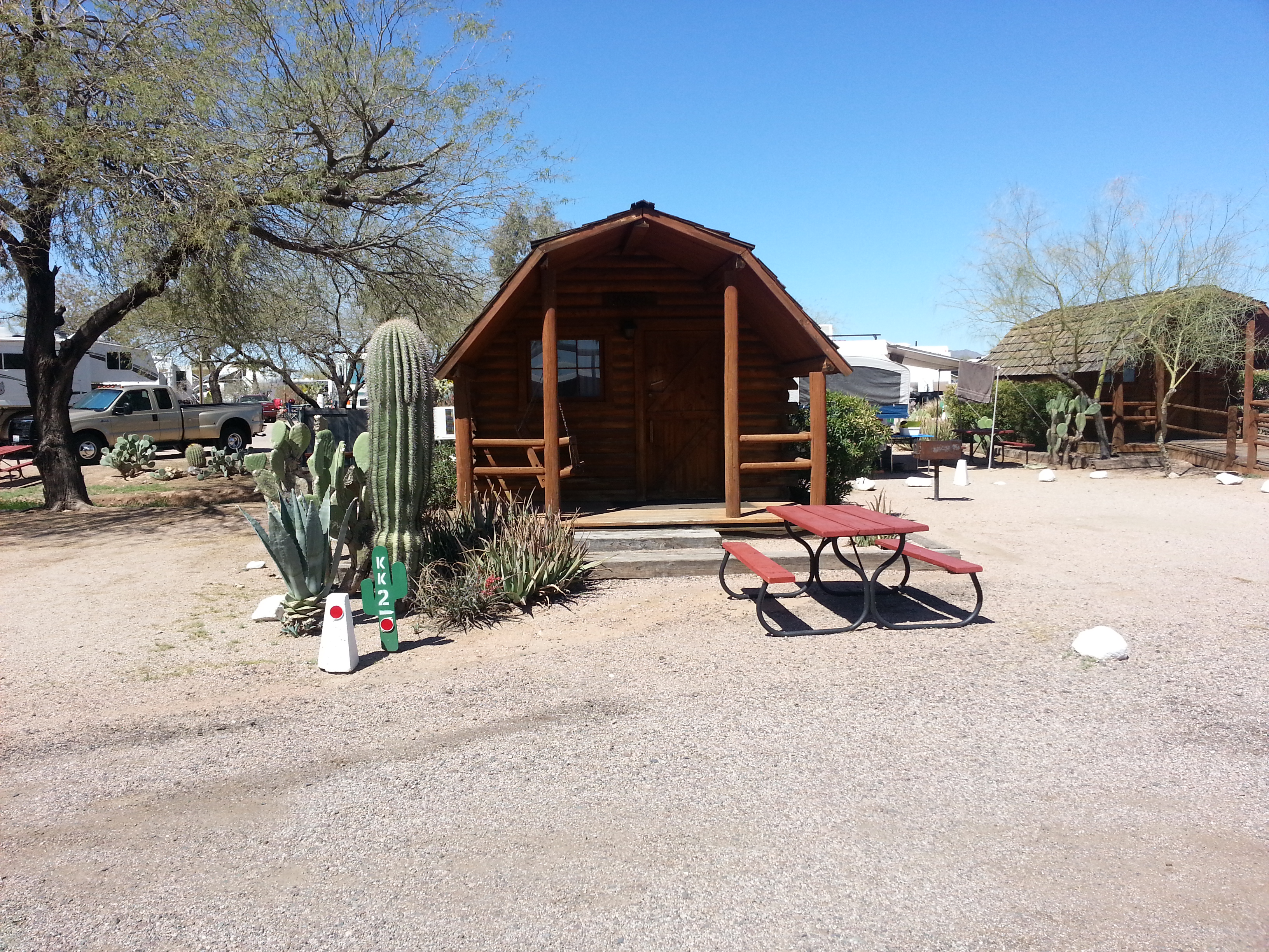 1 Room Camping Cabin (w/o Bathroom) These log cabins sleep 4 people in a double bed and two bunk beds. Sit in the front porch swing and enjoy the view of the Superstition Mountains or cook dinner on the outdoor grill. No pets!
