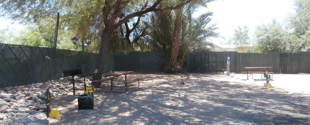 Tent Site, Water/Electric, Gravel Site Pad Enjoy a spacious water and electric site with a charcoal grill, picnic table and shade trees