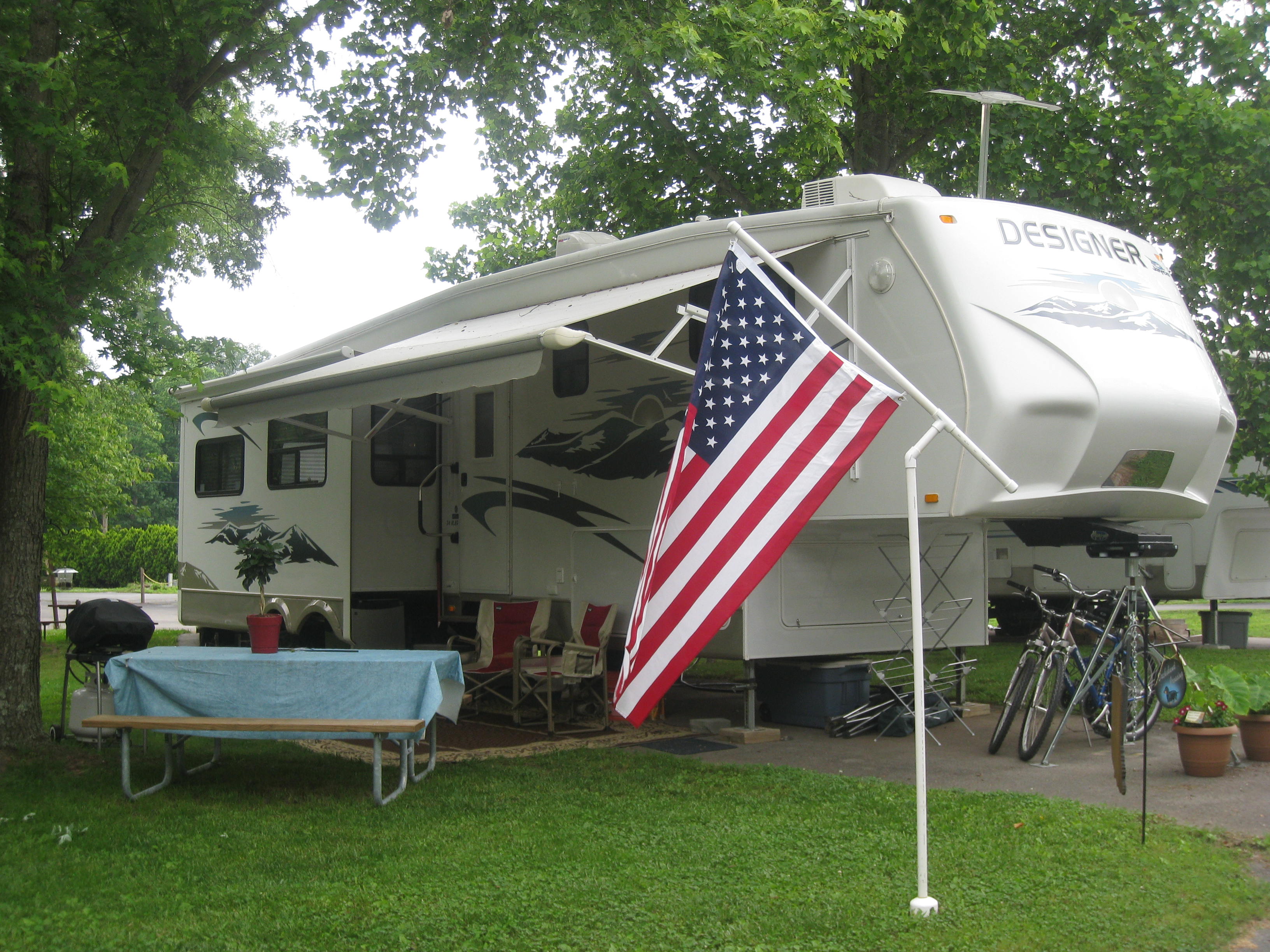 Back-in, full hookup, RV site. These beautiful sites are set among established trees for shaded comfort and relaxation.