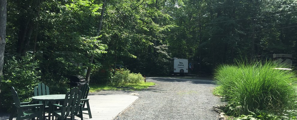 Deluxe Patio Site. Dining Set and Grill Provided. Fire Ring Provided at Every Site. No Picnic Table.