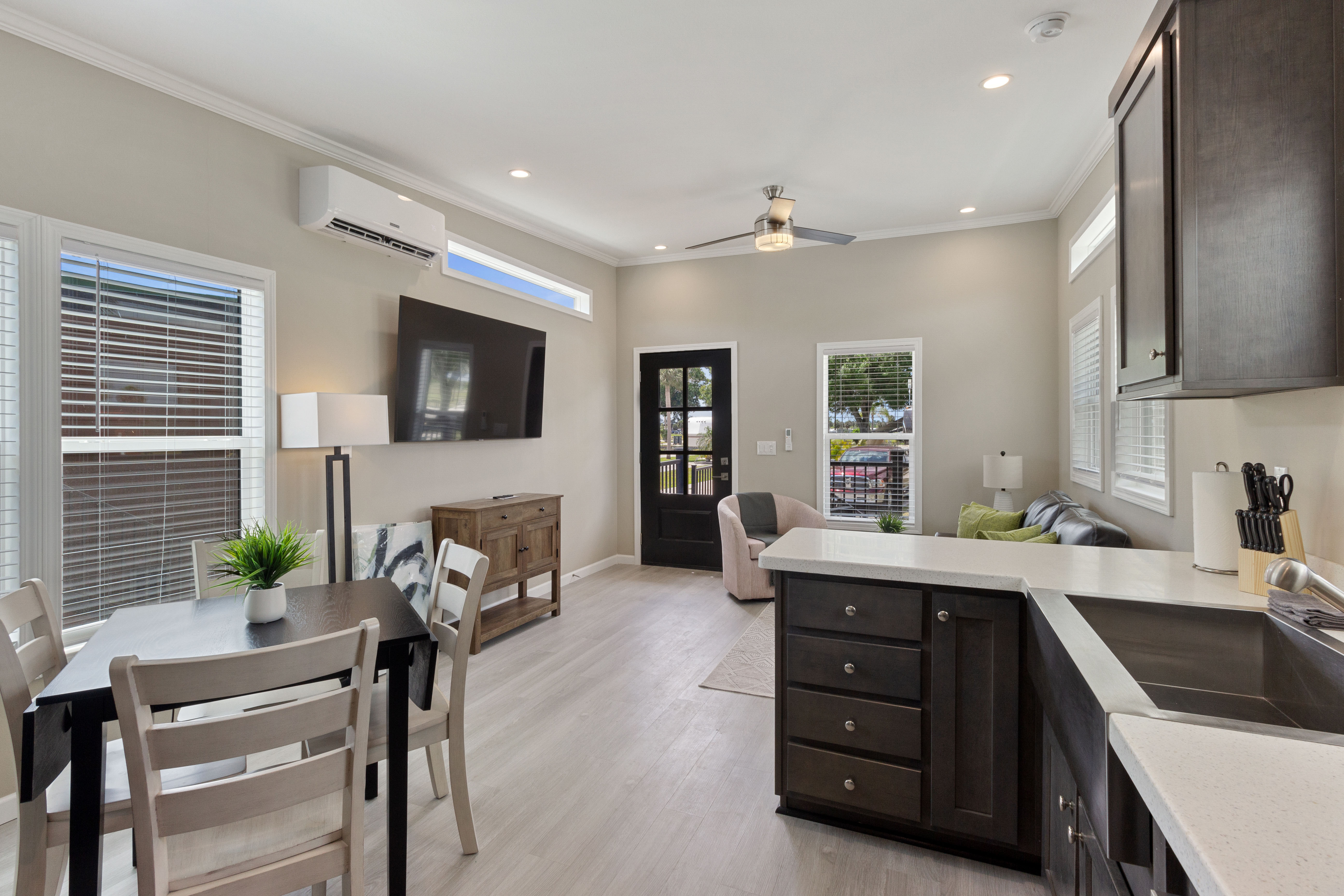 Kitchen, dining area, and couch with television