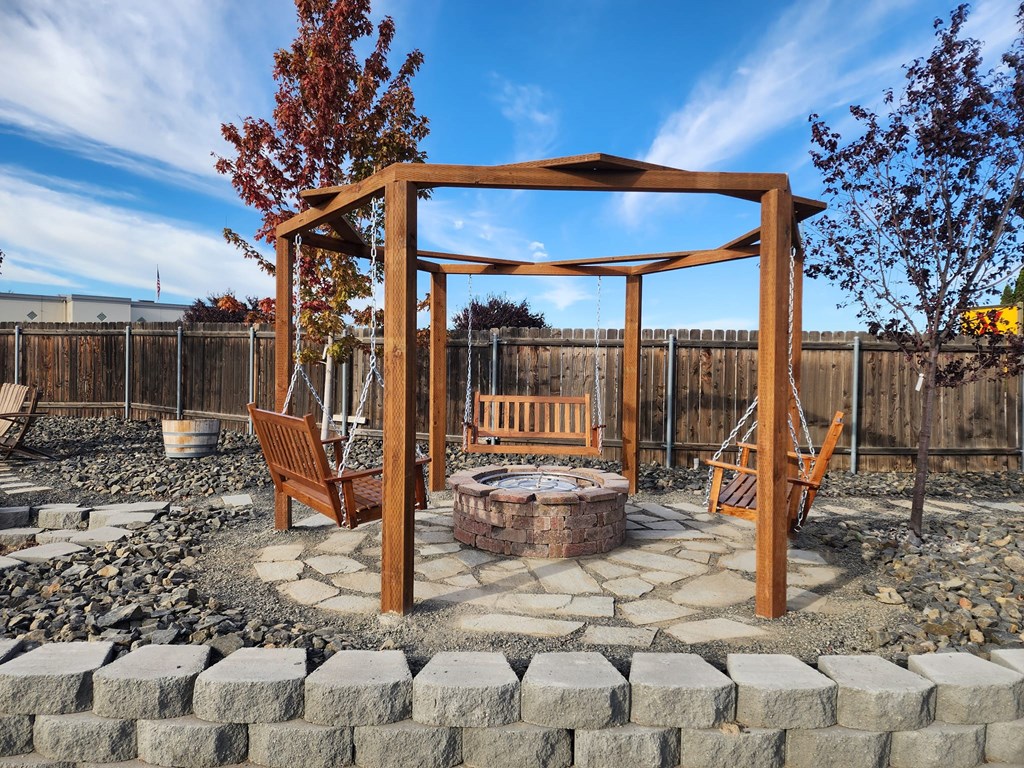 Swing gazebo with propane fire pit.