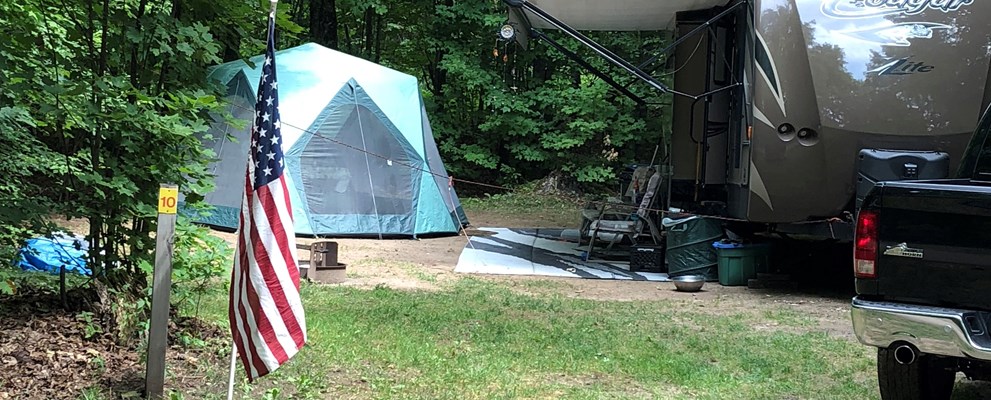 This is a site in one of our favored spots backing up to the woods, 50 amp service with water and electric.
