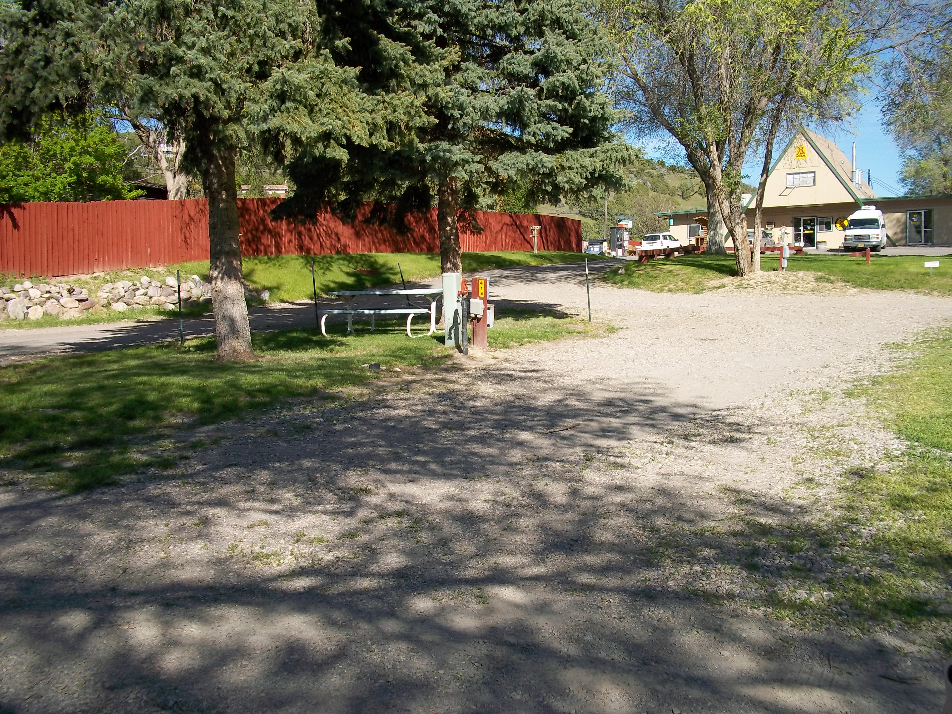 Nice site on the end of the row with large pine tree for shade and grass.