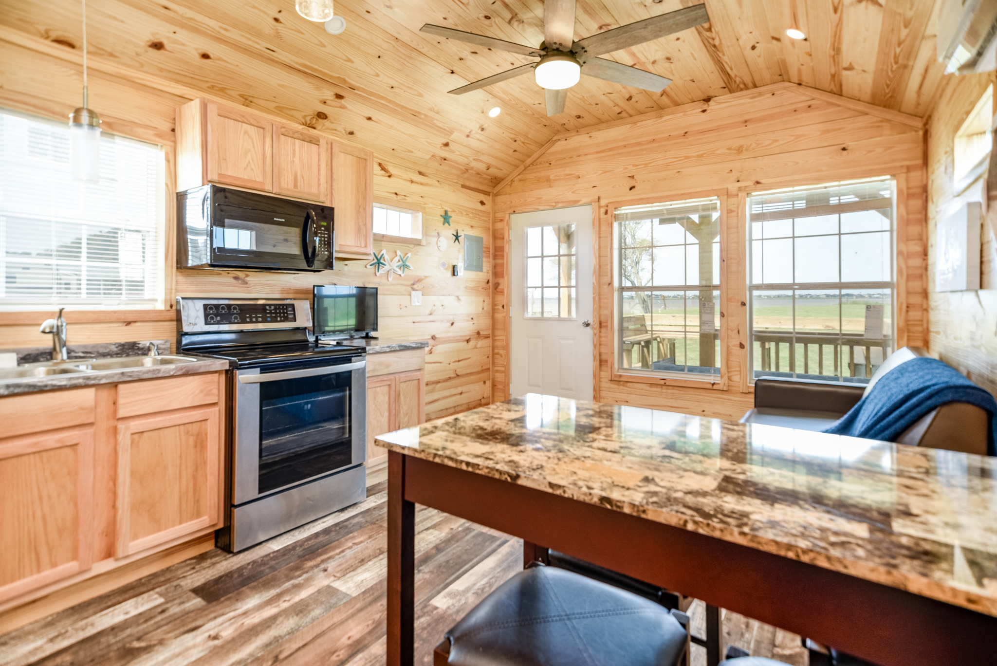 Our one bedroom cabin offers a kitchen area, dining table and a living space to relax on the sofa!