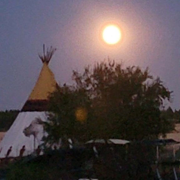 Moon shining on one of our tipis