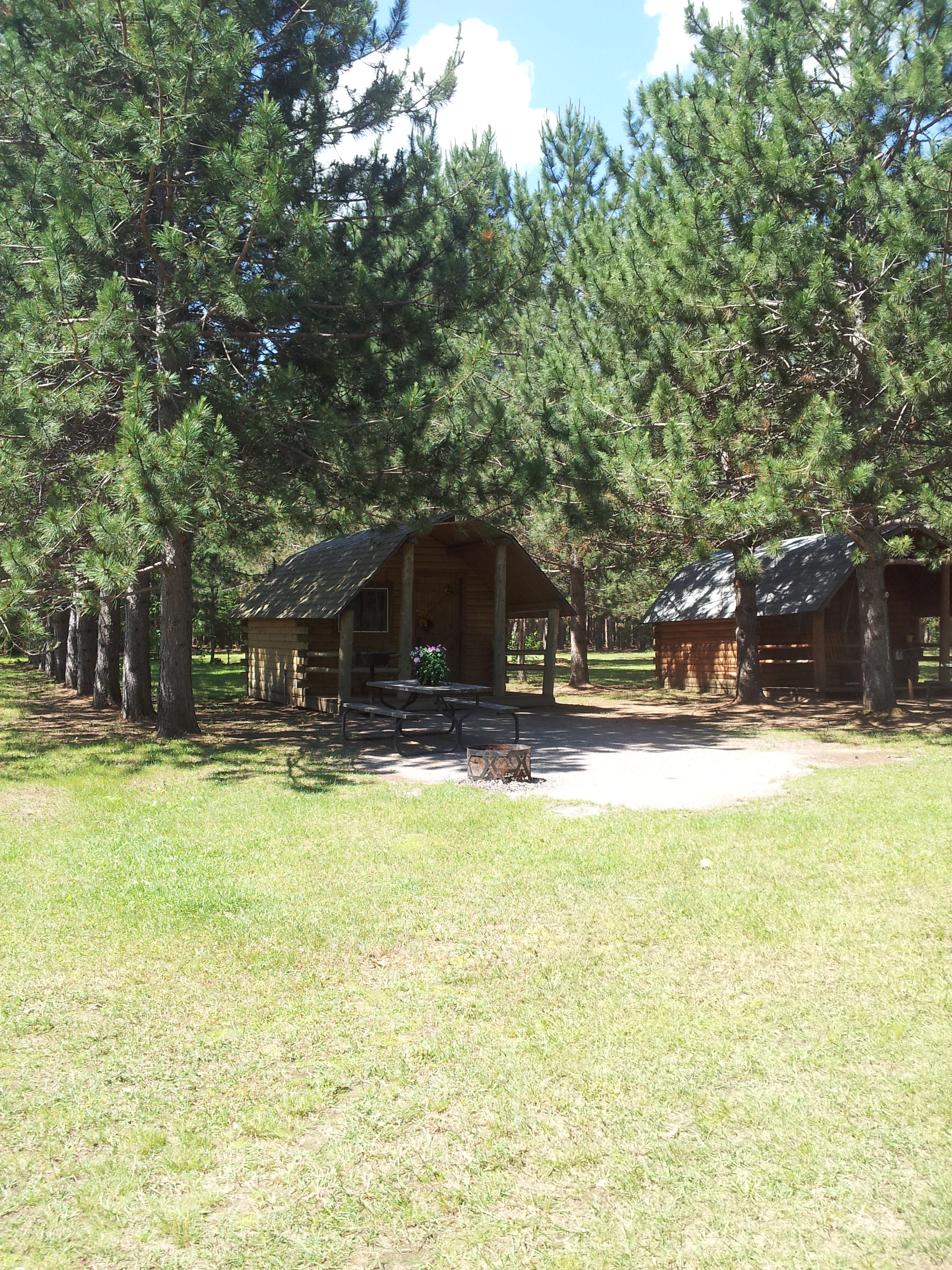 Beautiful cabin set in the pines with view of the lake. Sleeps 4, has power and a mini-fridge included.